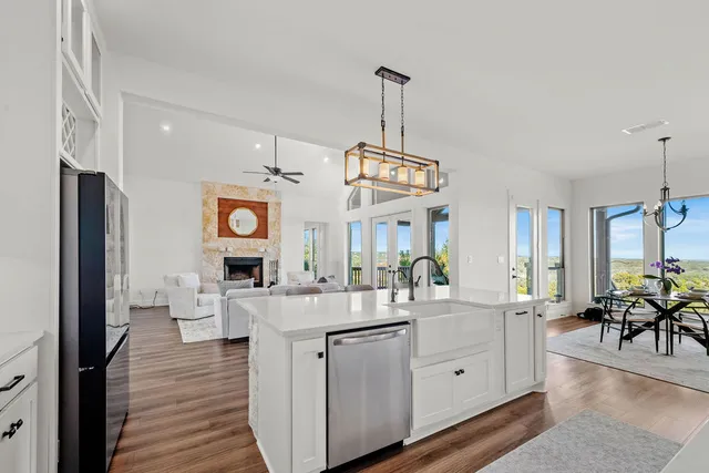 a kitchen with stainless steel appliances granite countertop a refrigerator and a sink
