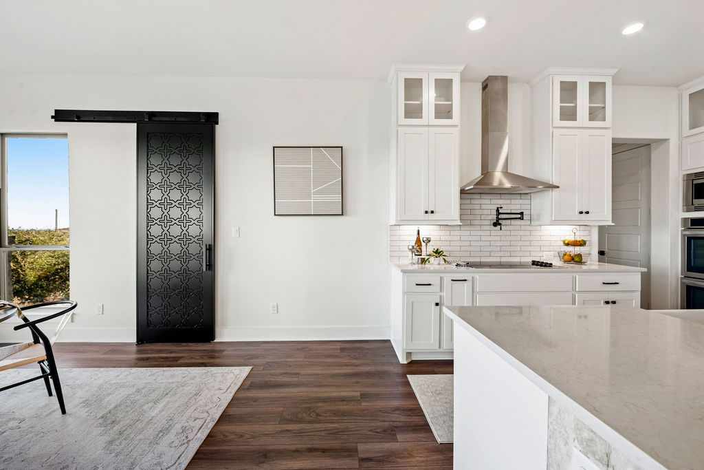 213 Lets Roll Drive Fischer, TX 78623 - Photo 19 of 38 a kitchen with stainless steel appliances granite countertop a refrigerator and a sink