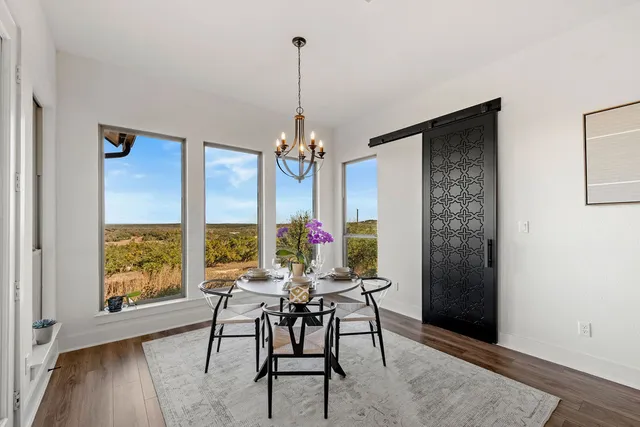 a bedroom with a bed and glass window