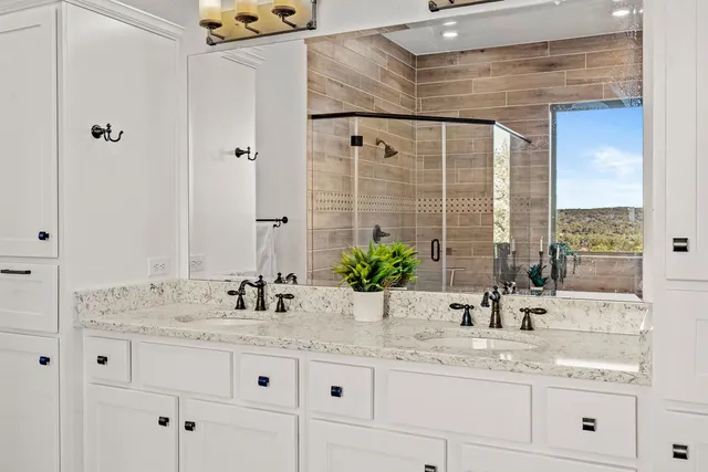 a bedroom with a bed a lamp and a chandelier