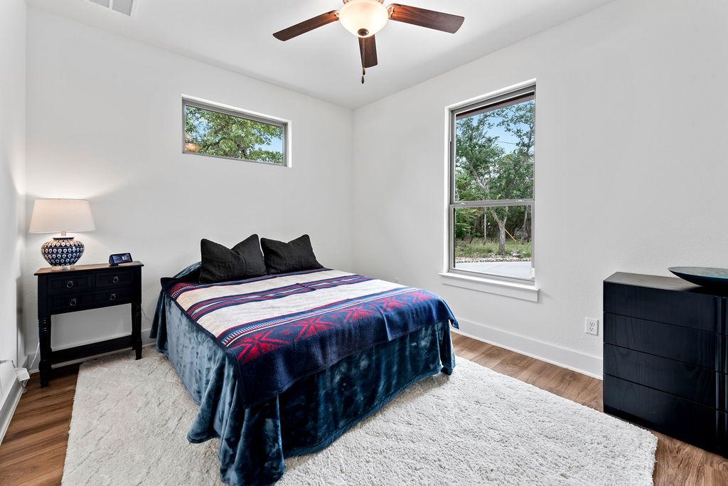 213 Lets Roll Drive Fischer, TX 78623 - Photo 29 of 38 Bedroom with wood finished floors, baseboards, and ceiling fan