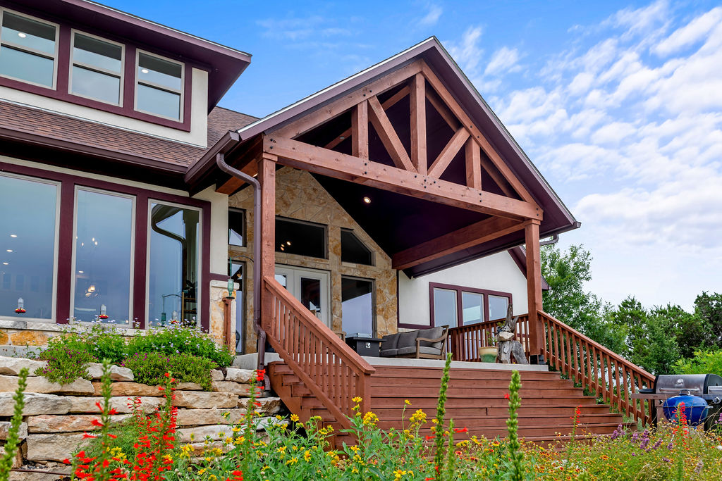 213 Lets Roll Drive Fischer, TX 78623 - Photo 31 of 38 Back of property featuring stairway, a shingled roof, and stone siding
