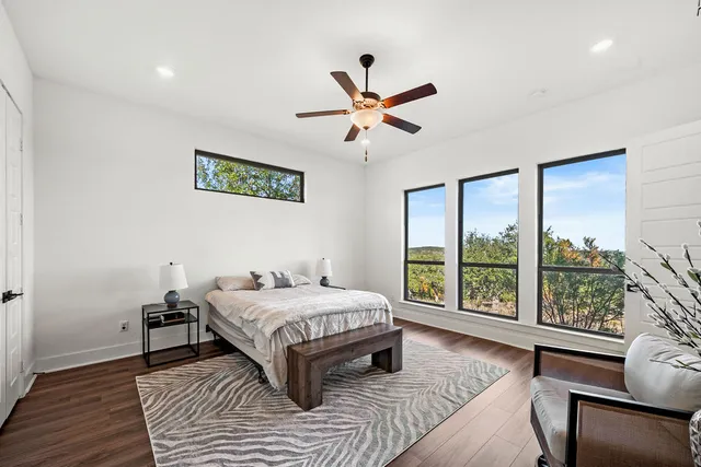 a bathroom with a granite countertop sink a mirror and shower