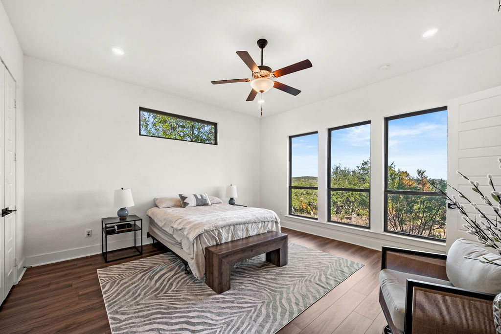 213 Lets Roll Drive Fischer, TX 78623 - Photo 5 of 38 a bedroom with a bed and a large window