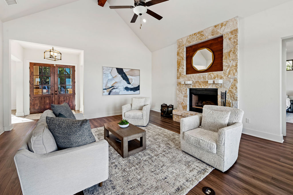 213 Lets Roll Drive Fischer, TX 78623 - Photo 10 of 38 a living room with furniture and a fireplace