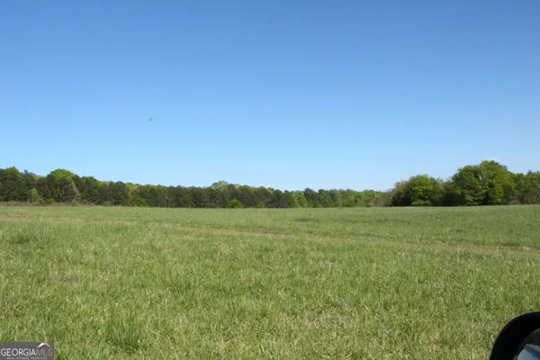 a view of an mountain and a yard