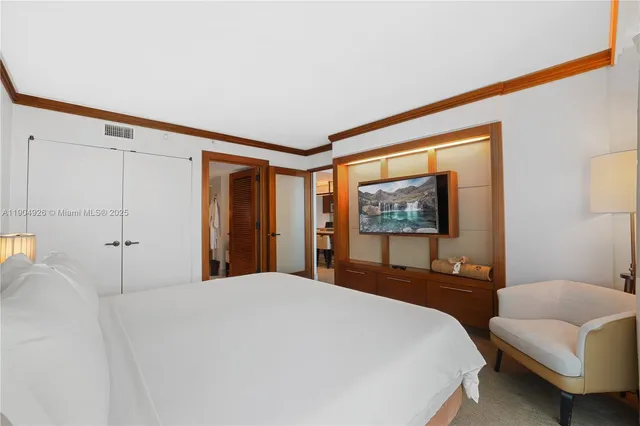 a bedroom with a large bed and a couch