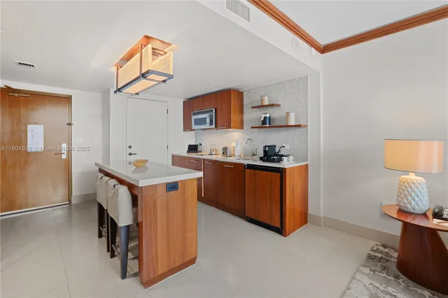 a view of kitchen with kitchen island and stainless steel appliances