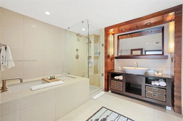 a bathroom with a double vanity sink mirror and shower