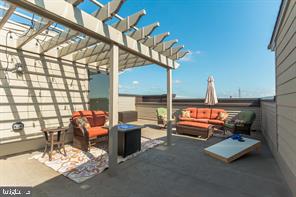 44782 Tiverton Square Ashburn, VA 20147 - Photo 13 of 26 a living room with furniture a chandelier and a floor to ceiling window