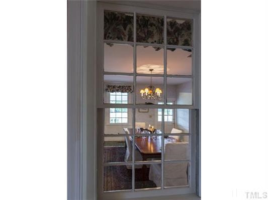 9123 South Lowell Road Bahama, NC 27503 - Photo 17 of 25 Which was once an exterior window where the original house was, now provides a charming glance into the Dining Room from the main hall. Charming Window