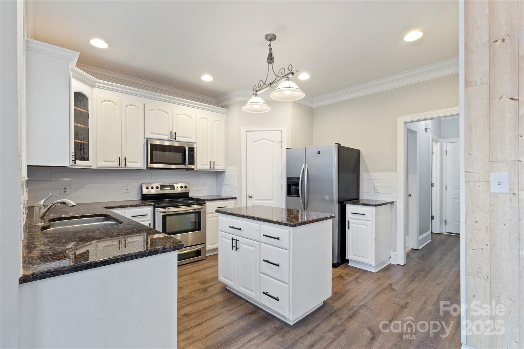 6655 Maple Spring Court Denver, NC 28037 - Photo 13 of 48 a kitchen with stainless steel appliances a stove refrigerator sink and microwave
