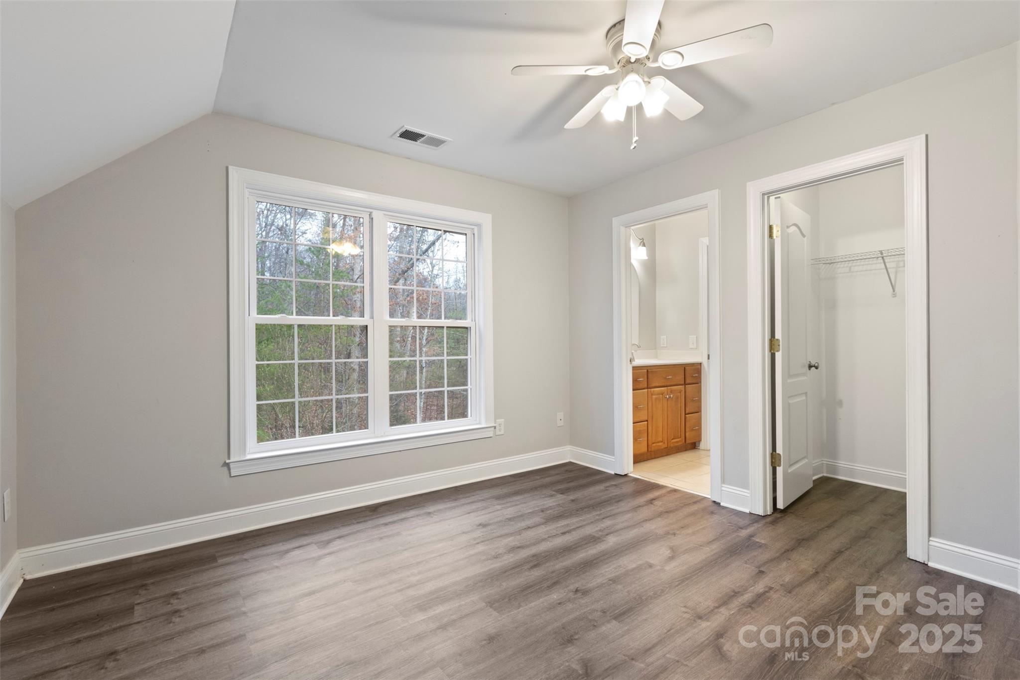 6655 Maple Spring Court Denver, NC 28037 - Photo 21 of 48 an empty room with wooden floor chandelier fan and windows