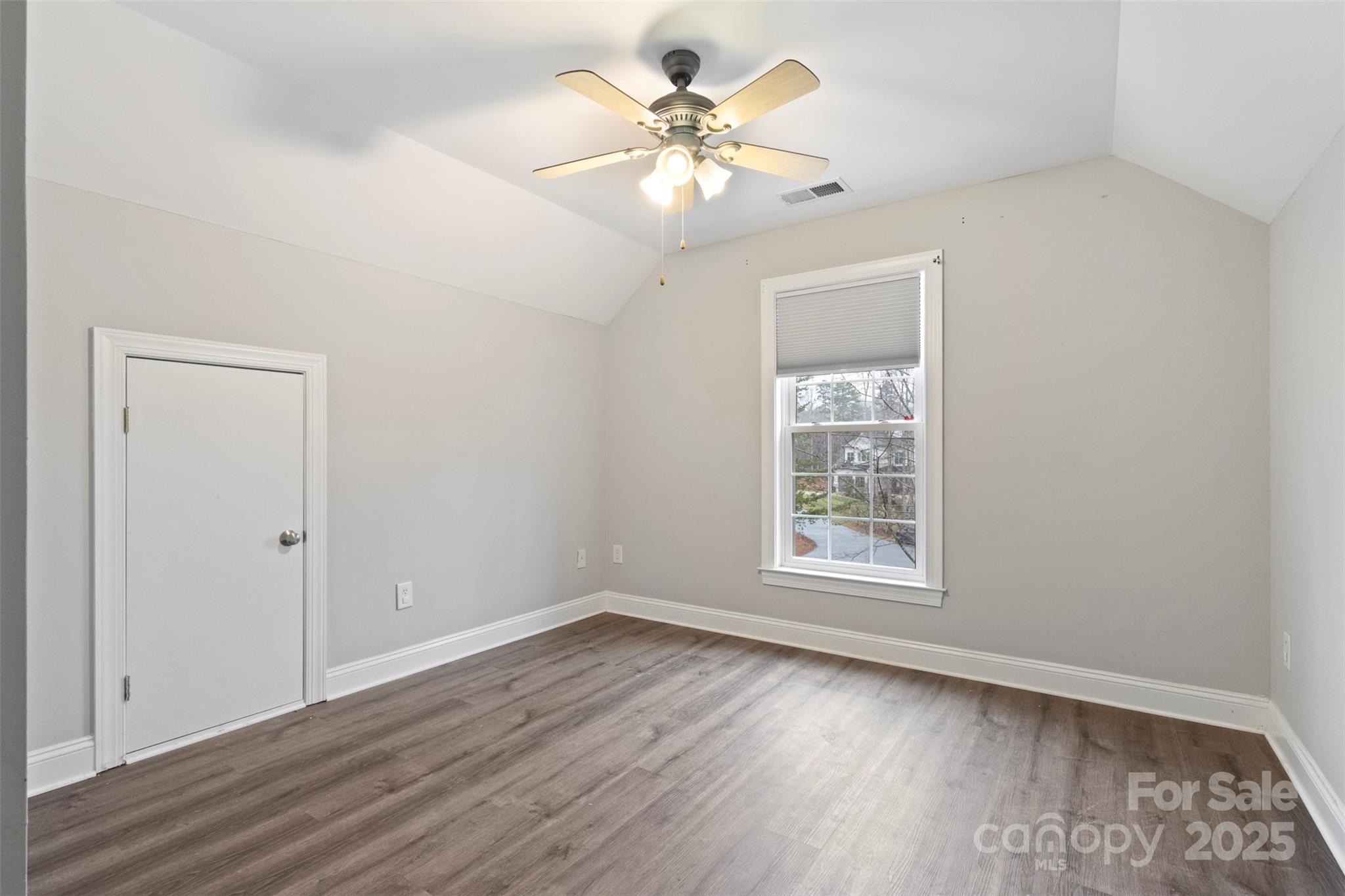 6655 Maple Spring Court Denver, NC 28037 - Photo 23 of 48 a view of an empty room with a window and wooden floor