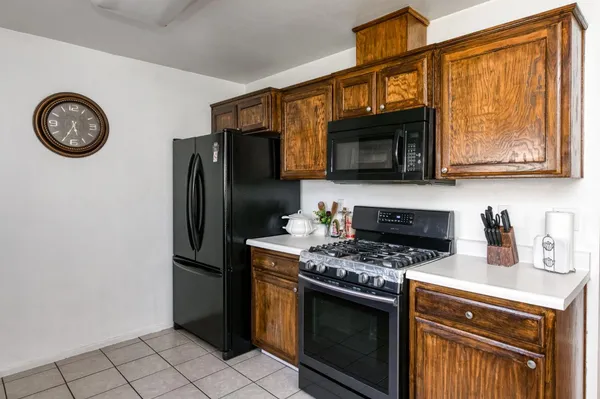 a kitchen with granite countertop a stove and a microwave