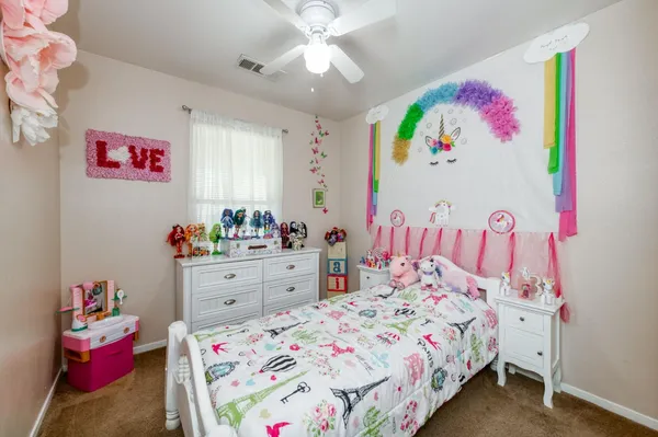 a bedroom that has a bed and a dresser in it
