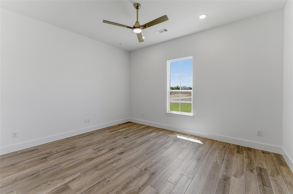 815 Vly Rdg Road Van Alstyne, TX 75495 - Photo 8 of 29 Bright interior space featuring a window, wood-finish flooring, a ceiling fan, recessed lighting, and white baseboards