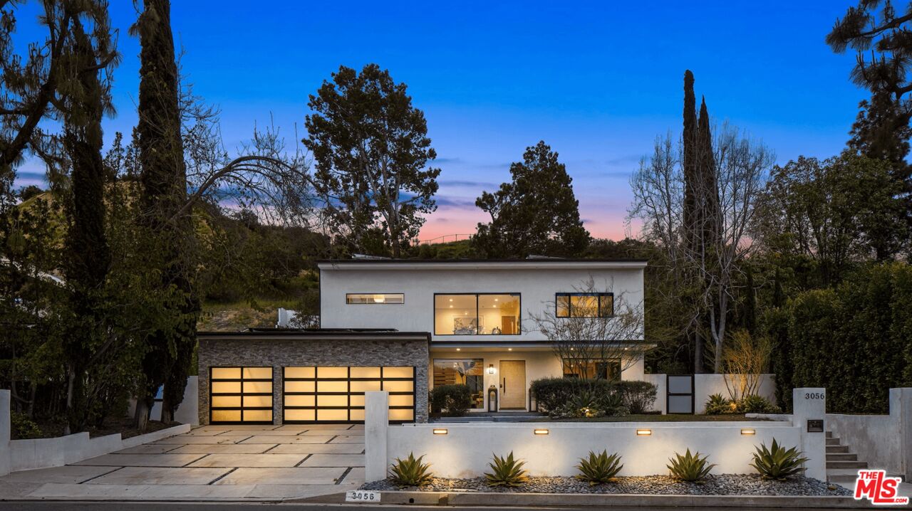 a view of house with outdoor space and sitting area