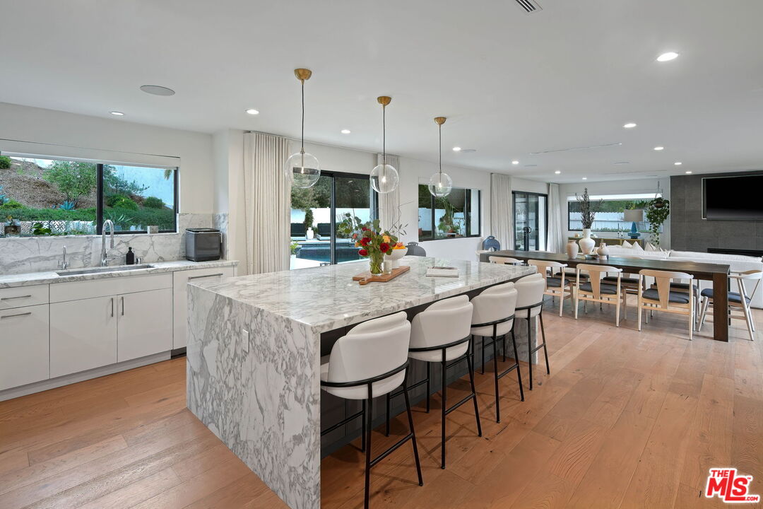 3056 Arrowhead Drive Los Angeles, CA 90068 - Photo 11 of 35 a kitchen with lots of counter top space and painting on the wall