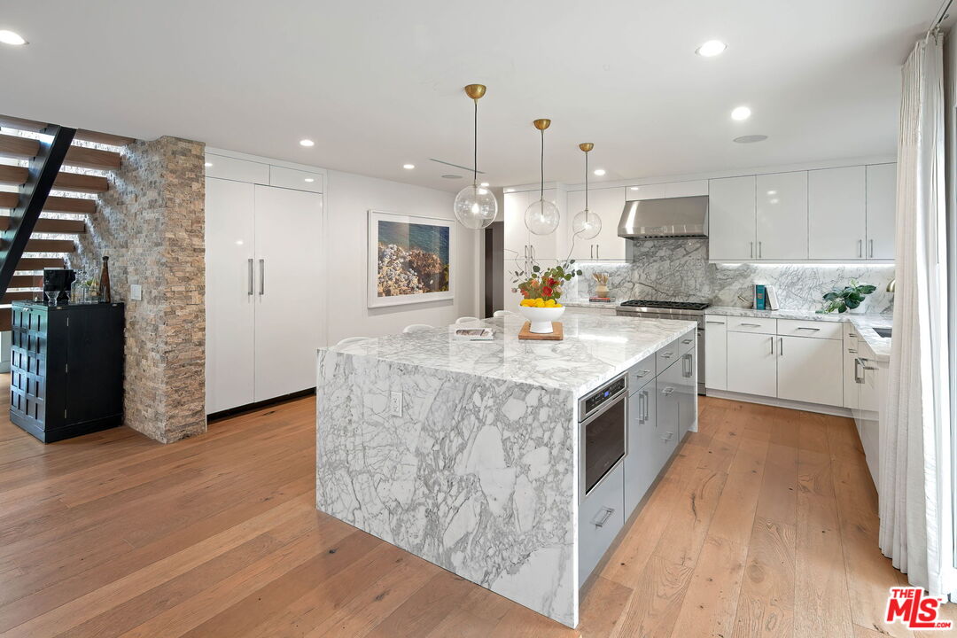 3056 Arrowhead Drive Los Angeles, CA 90068 - Photo 12 of 35 a kitchen with stainless steel appliances granite countertop a stove a sink dishwasher and a refrigerator with wooden floor
