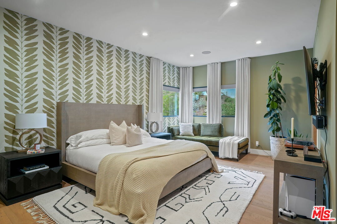 3056 Arrowhead Drive Los Angeles, CA 90068 - Photo 13 of 35 a large bedroom with a bed and a couch