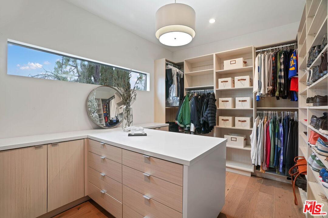 3056 Arrowhead Drive Los Angeles, CA 90068 - Photo 17 of 35 a view of walk in closet with clothes and shoes