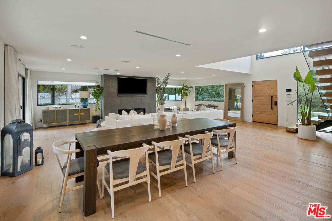 3056 Arrowhead Drive Los Angeles, CA 90068 - Photo 8 of 35 a kitchen with stainless steel appliances kitchen island granite countertop a table and chairs in it