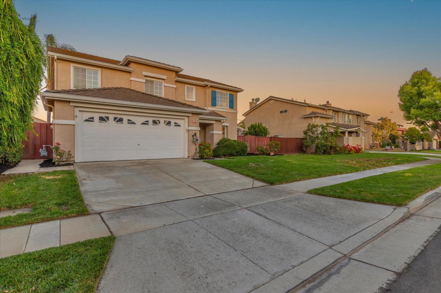 9182 El Verano Way Gilroy, CA 95020 - Photo 42 of 89 a view of a white house with a big yard and large tree