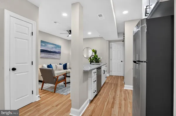 a view of a hallway to a livingroom and a dinning room