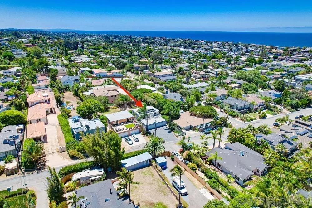 an aerial view of residential houses with outdoor space and street view