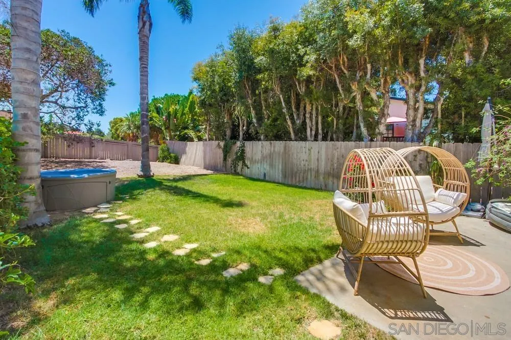 303-305 Sanford Street Encinitas, CA 92024 - Photo 21 of 41 a view of a chair and table in backyard of the house