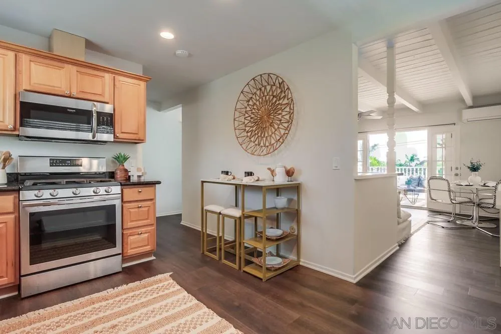 303-305 Sanford Street Encinitas, CA 92024 - Photo 29 of 41 a kitchen with stainless steel appliances a stove a microwave a sink and cabinets