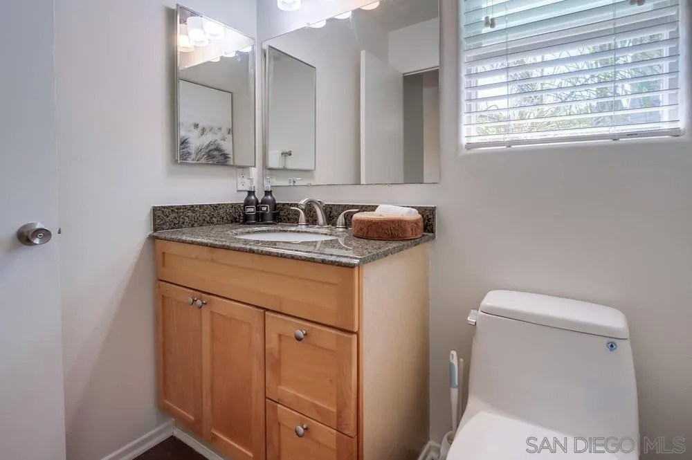303-305 Sanford Street Encinitas, CA 92024 - Photo 31 of 41 a bathroom with a sink toilet and mirror