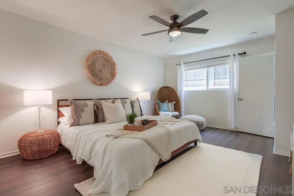303-305 Sanford Street Encinitas, CA 92024 - Photo 32 of 41 a bedroom with bed and a chandelier