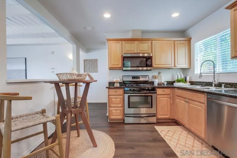 303-305 Sanford Street Encinitas, CA 92024 - Photo 10 of 41 a kitchen with stainless steel appliances granite countertop a stove a sink a microwave and a refrigerator