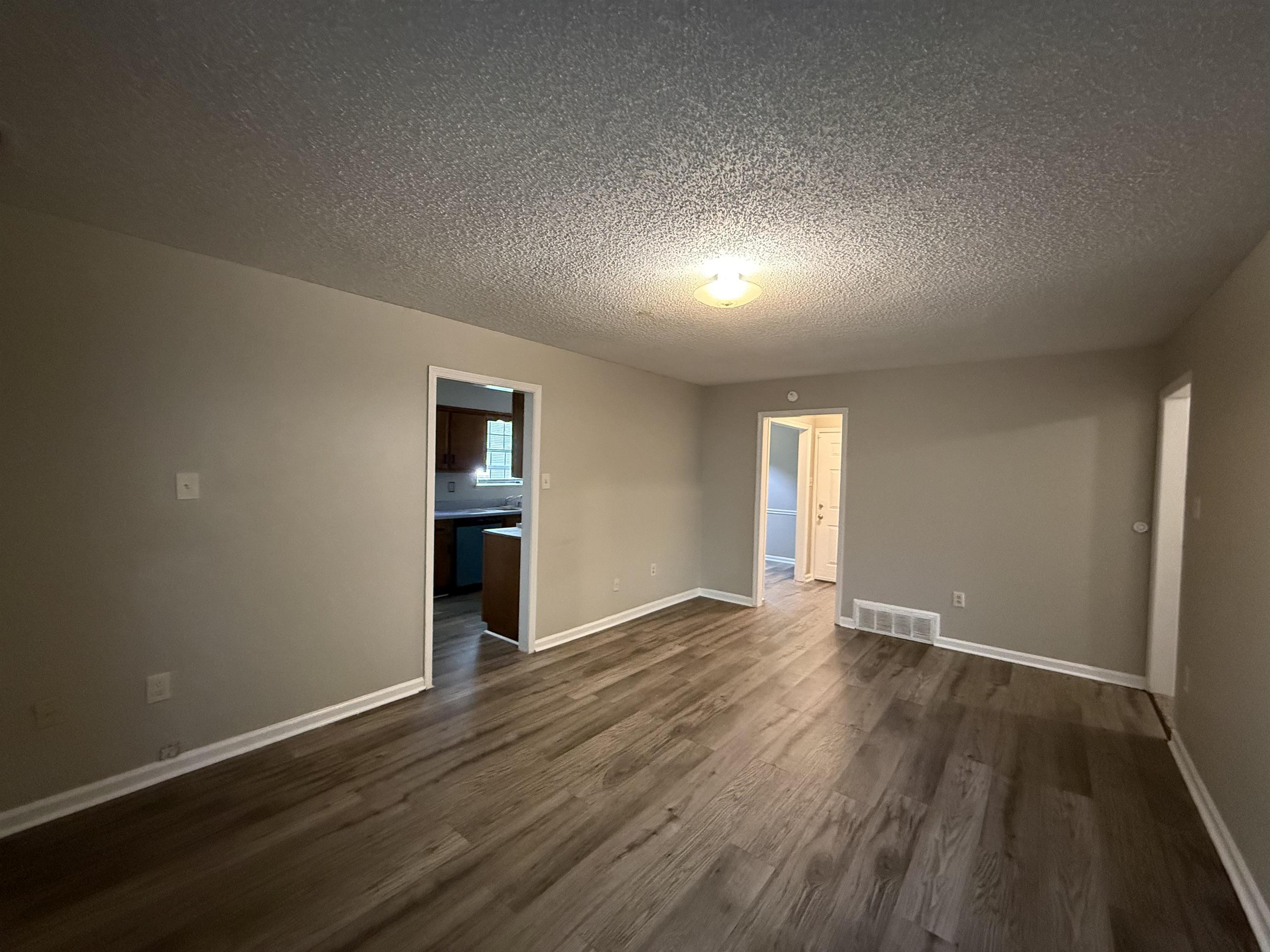 6420 Saginaw Road Memphis, TN 38134 - Photo 3 of 38 Interior space featuring wood-finish flooring, light neutral-toned walls, and white baseboards
