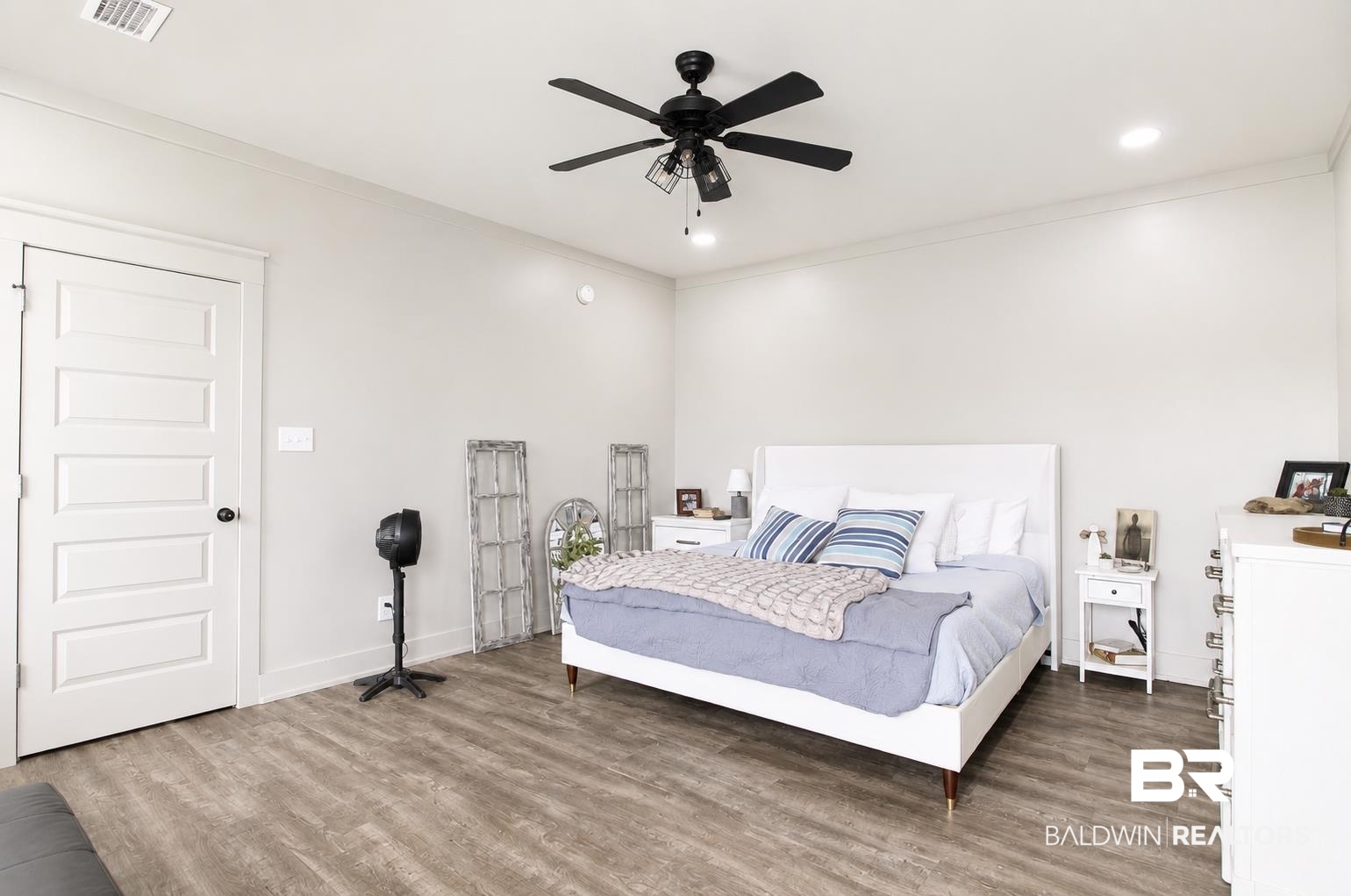 9825 Wolf Creek Ridge Elberta, AL 36530 - Photo 18 of 76 Spacious room featuring wood-finish flooring, a ceiling fan with integrated lighting, recessed lighting, and a five-panel interior door with black hardware