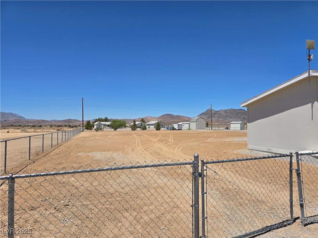 330 Gilmore Road Pahrump, NV 89060 - Photo 37 of 42 Side yard on left of home with adjoining vacant lot next door.