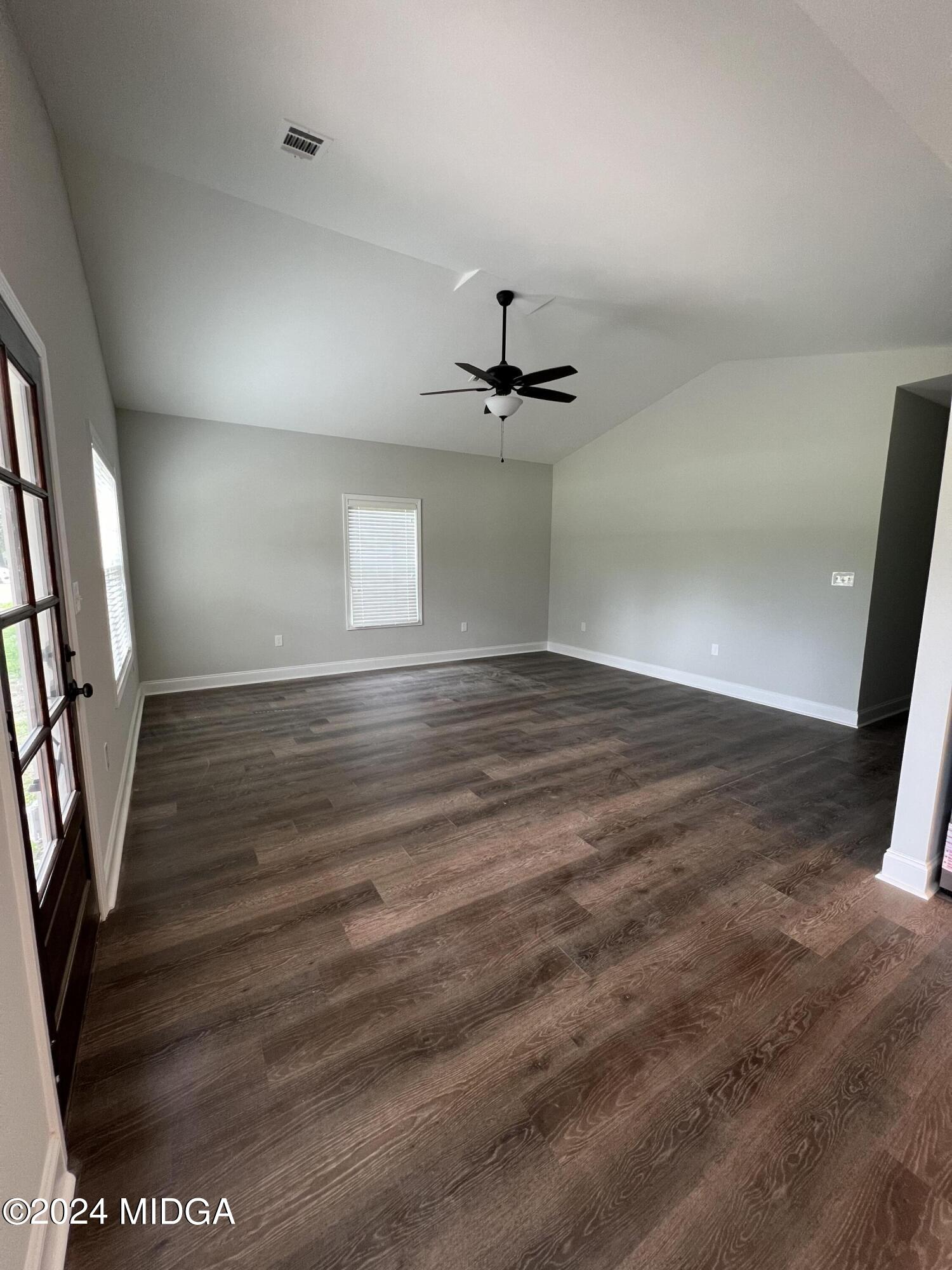 426 Walker Road Byron, GA 31008 - Photo 8 of 24 wooden floor in an empty room with a mirror