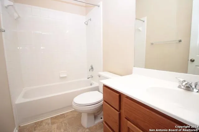a bathroom with a sink a toilet and bathtub