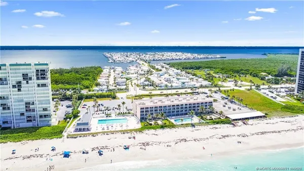 an aerial view of a house with a yard basket ball court and outdoor seating