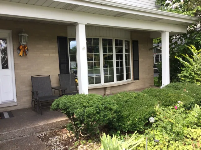 a living room with furniture and a painting on the wall