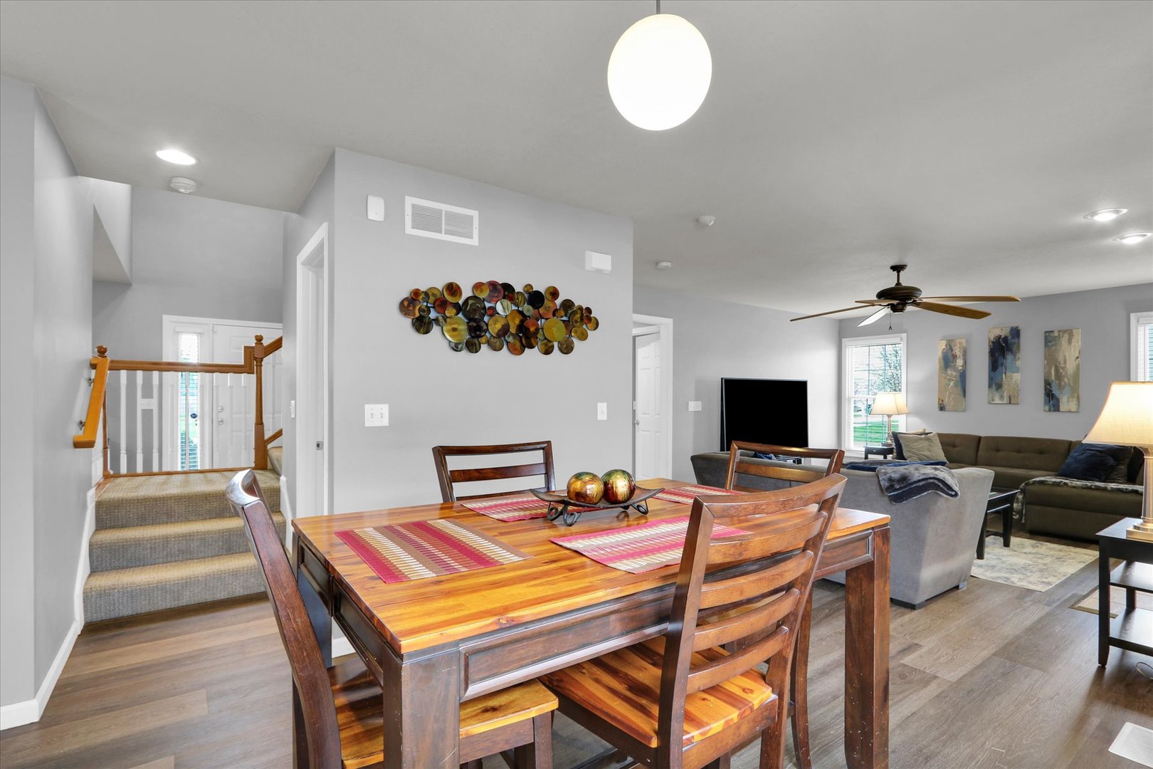 3808 Pebblebrook Lane Champaign, IL 61822 - Photo 11 of 31 a living room with a table chairs and a flat screen tv
