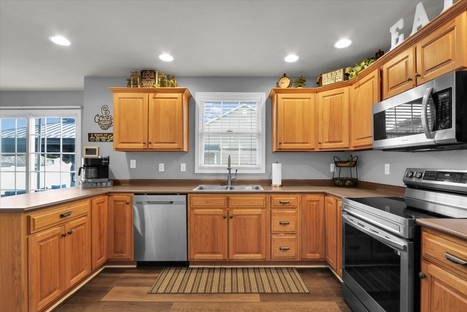 3808 Pebblebrook Lane Champaign, IL 61822 - Photo 14 of 31 a kitchen with stainless steel appliances granite countertop a sink and wooden cabinets