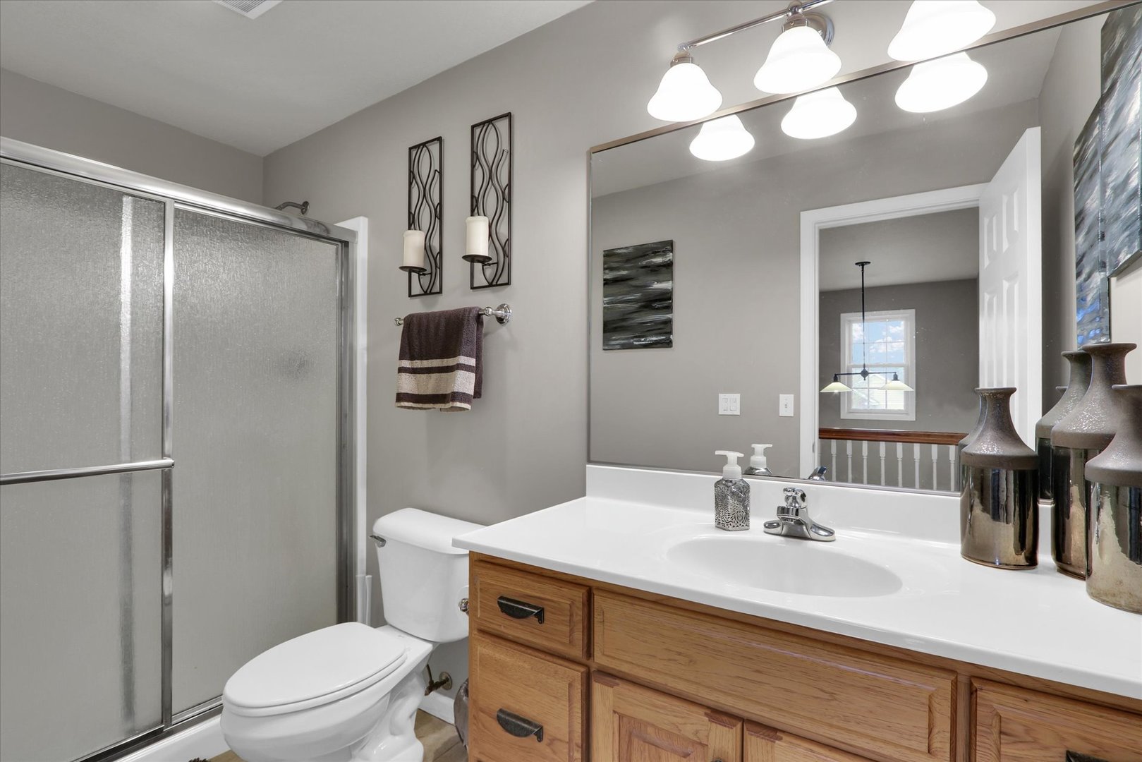 3808 Pebblebrook Lane Champaign, IL 61822 - Photo 23 of 31 a bathroom with a sink toilet vanity and shower