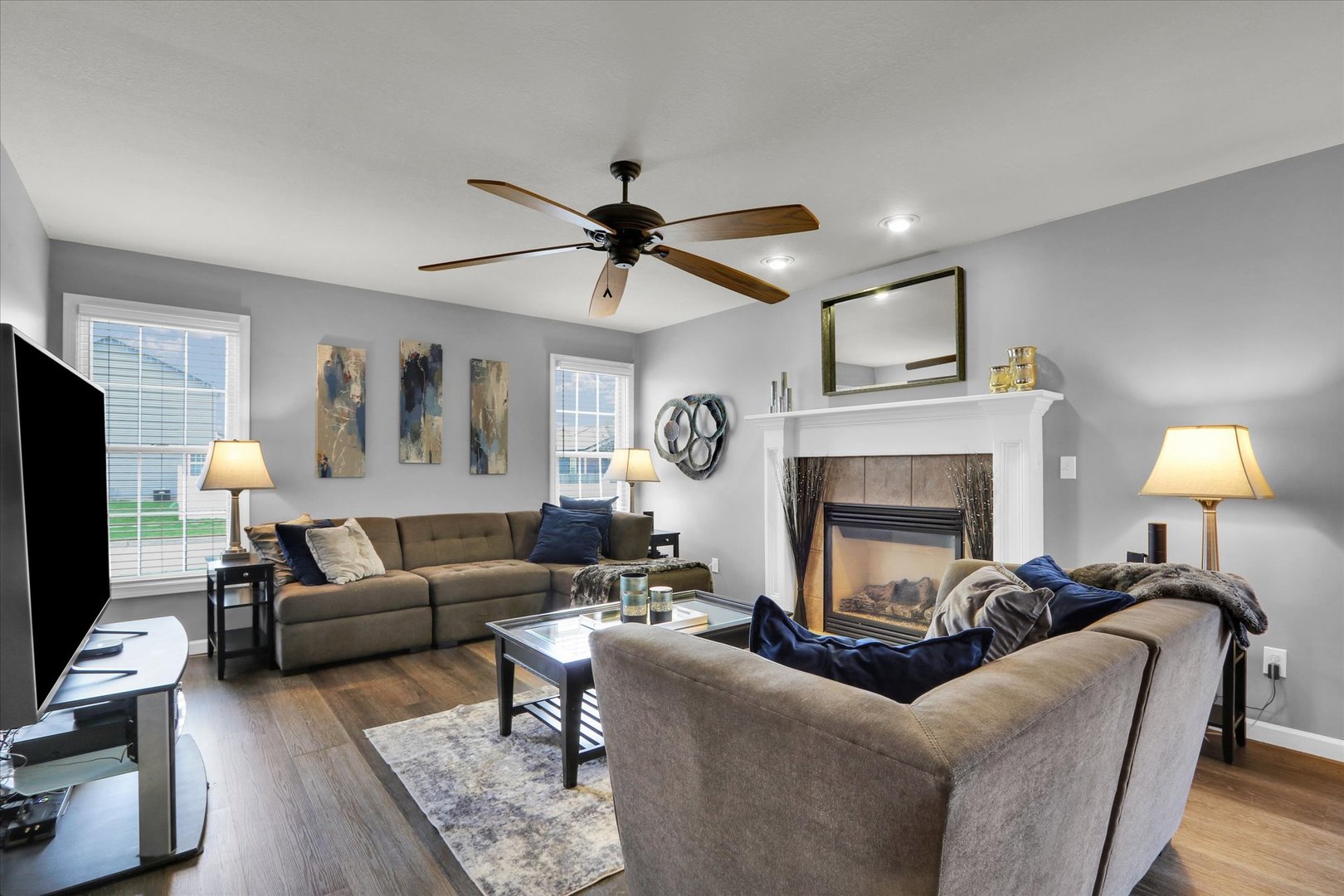 3808 Pebblebrook Lane Champaign, IL 61822 - Photo 6 of 31 a living room with furniture a fireplace and a flat screen tv
