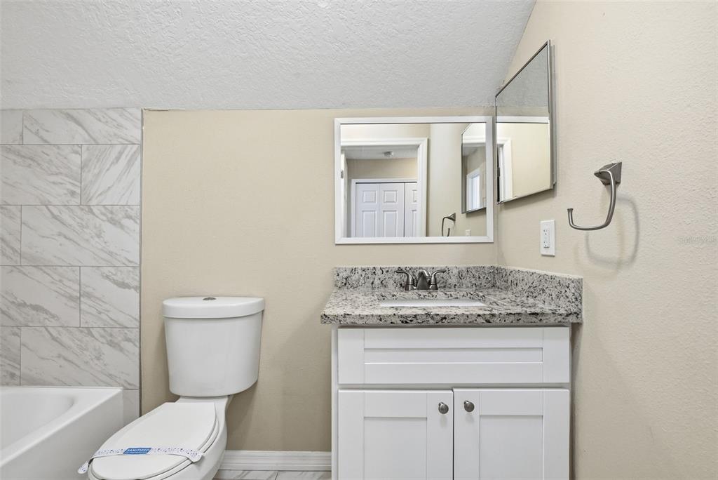 617 Greys Ferry Road Orlando, FL 32811 - Photo 27 of 35 a bathroom with a granite countertop sink toilet and shower
