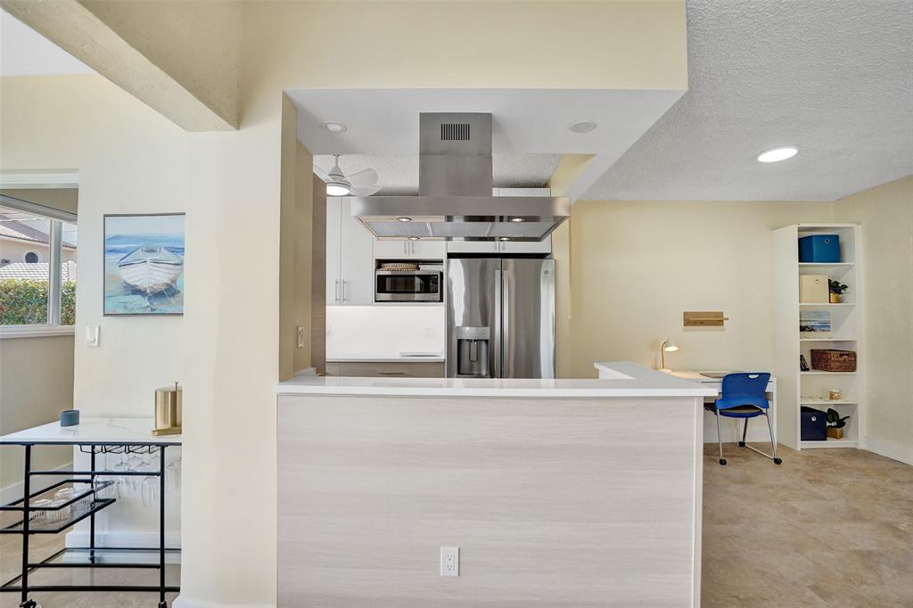 5700 Old Ocean Boulevard, Unit X Ocean Ridge, FL 33435 - Photo 12 of 49 a kitchen with stainless steel appliances kitchen island a chandelier
