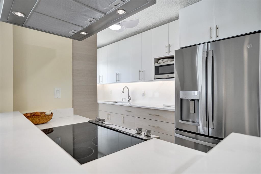 5700 Old Ocean Boulevard, Unit X Ocean Ridge, FL 33435 - Photo 14 of 49 a kitchen with stainless steel appliances refrigerator and microwave