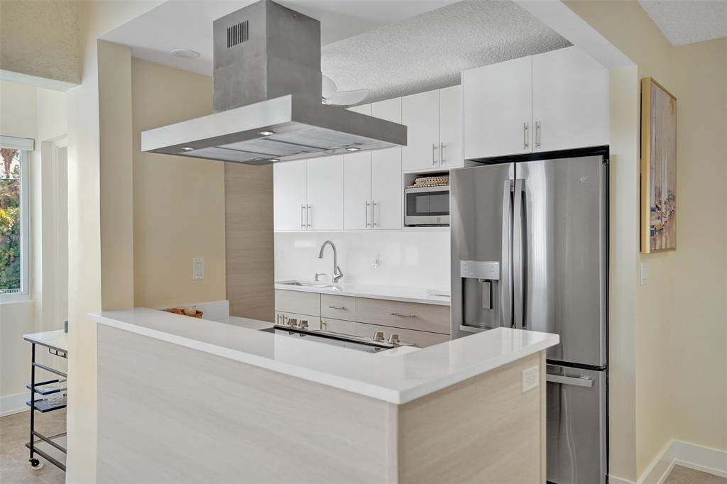 5700 Old Ocean Boulevard, Unit X Ocean Ridge, FL 33435 - Photo 15 of 49 a kitchen with stainless steel appliances a refrigerator and a stove